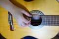 Female hand playing on acoustic guitar. Close-up Royalty Free Stock Photo