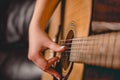 Female hand playing on acoustic guitar Royalty Free Stock Photo