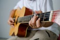 Female hand playing music by acoustic guitar - Close up shot and Royalty Free Stock Photo