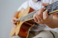 Female hand playing music by acoustic guitar - Close up shot and Royalty Free Stock Photo