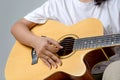 Female hand playing music by acoustic guitar - Close up shot and Royalty Free Stock Photo