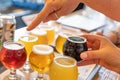 Female Pointing to Glass of Micro Brew Beer From Variety