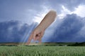 female hand points with index finger, dramatic thunderstorm sky with dark clouds, concept God's punishment, retribution for