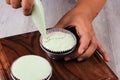 Female Hand Pour Green Cupcake Batter to the Mold with Beatiful Papercup, Baking Process Step by Step in the Kitchen