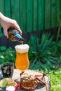 A female hand pouring beer from the bottle into a glass Royalty Free Stock Photo