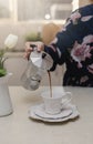 Female hand pouring coffee in a cup Royalty Free Stock Photo