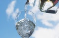 Female hand pouring water from bottle to glass Royalty Free Stock Photo