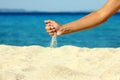 Female hand pours sand Royalty Free Stock Photo