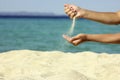 Female hand pours sand Royalty Free Stock Photo