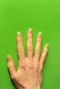 Female hand pressed against bright green wall - minimal