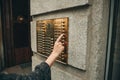 Hand presses the intercom button Royalty Free Stock Photo