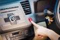 Female hand pressing emergency light button on car dashboard. Royalty Free Stock Photo