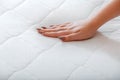 Female hand Pressing Testing mattress to Check softness. Choice comfortable mattress for sleep in store. quality control hardness Royalty Free Stock Photo