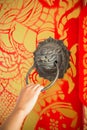 Female hand pulling brass lion head door knocker on painted wood Royalty Free Stock Photo