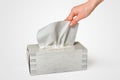 Female hand pulling white facial tissue from a box Royalty Free Stock Photo