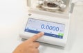 Female hand push the digital Hydrostatic Weighing Balance for examine the specific gravity for separate the type of precious stone Royalty Free Stock Photo