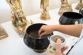 Female hand put thai coin in monk alms bowl to make merit