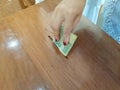 Female hand put thai money in wood box