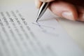 Female hand puts signature example sample document or contract with text lorem ipsum, selective focus Royalty Free Stock Photo