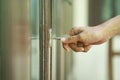 Female hand putting house key into front door lock of house Royalty Free Stock Photo