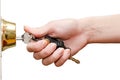 Female hand putting house key into front door lock isolated