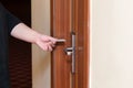 Female hand putting key card switch in to open hotel room door Royalty Free Stock Photo