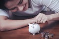 Female hand putting money into piggy bank. Royalty Free Stock Photo