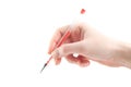Female hand is ready for drawing with a red pen Royalty Free Stock Photo
