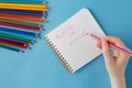 Female hand ready to writhe phrase in notebook Royalty Free Stock Photo