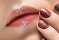 Female hand with red nail design. Brown nail polish manicured hand. Pink female lips design close up Royalty Free Stock Photo