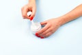 Female hand with red nail polish and unbranded open cream jar . Flacon for cream, toiletry. Bottle for professional cosmetics