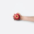 Female hand with red nails hold red apple