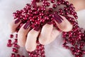 Elegant Winter Glamour: Red Wine Manicure with Pearl Accent