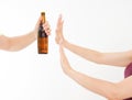 Female hand reject a bottle of beer isolated on white background.anti alcohol concept. Copy space Royalty Free Stock Photo