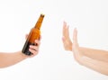 Female hand reject a bottle of beer isolated on white background.anti alcohol concept. Copy space Royalty Free Stock Photo