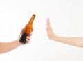 Female hand reject a bottle of beer isolated on white background.anti alcohol concept. Copy space Royalty Free Stock Photo