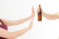 Female hand reject a bottle of beer isolated on white background.anti alcohol concept. Copy space Royalty Free Stock Photo