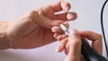 female hand removes nail polish with a milling cutter