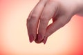 Female hand with ripe red gooseberry berry. Red lights Royalty Free Stock Photo