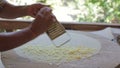 Female hand rub cheese on a grater