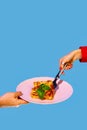 Female hand serving delicious Italian food, putting lasagna on plate over green and blue background Royalty Free Stock Photo