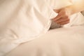 Female Hand set up white bed sheet in room hotel Royalty Free Stock Photo