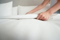 Female Hand set up white bed sheet in room hotel Royalty Free Stock Photo