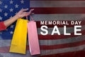 Female hand with shopping bag on memorial day sale Royalty Free Stock Photo
