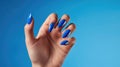 A female hand showcases elegant blue nail design art, featuring abstract manicure fingernail patterns, Ai Generated Royalty Free Stock Photo