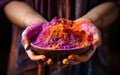 Female hand showcasing bowl of colorful powder, holi festival image download