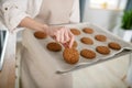 Female hand showing just baked beautiful cookies.