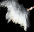 Female hand sifts white wheat flour through a round wooden sieve on a black background Royalty Free Stock Photo