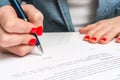 Female hand signing contract to conclude a deal Royalty Free Stock Photo