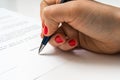 Female hand signing contract to conclude a deal Royalty Free Stock Photo